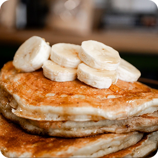Sliced bananas atop sourdough pancakes